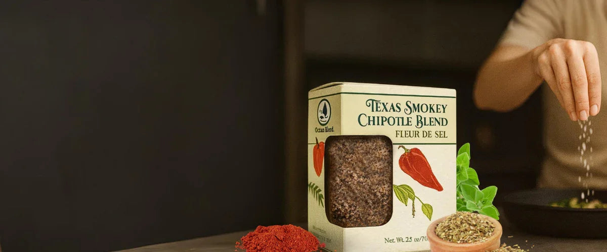 Texas Smokey Chipotle Blend seasoning box with spices and hand sprinkling salt into a pan