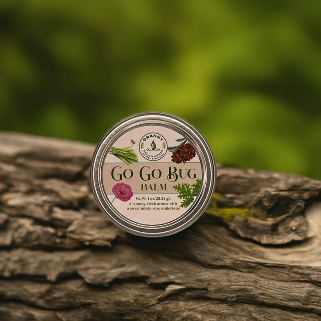 Go Go Bug Balm tin on tree bark outdoors, natural insect repellent product photo