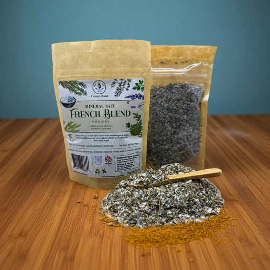 Two packages of 'French Blend' mineral salt with a scoop of salt on a wooden surface. Finishing Sea Salt.