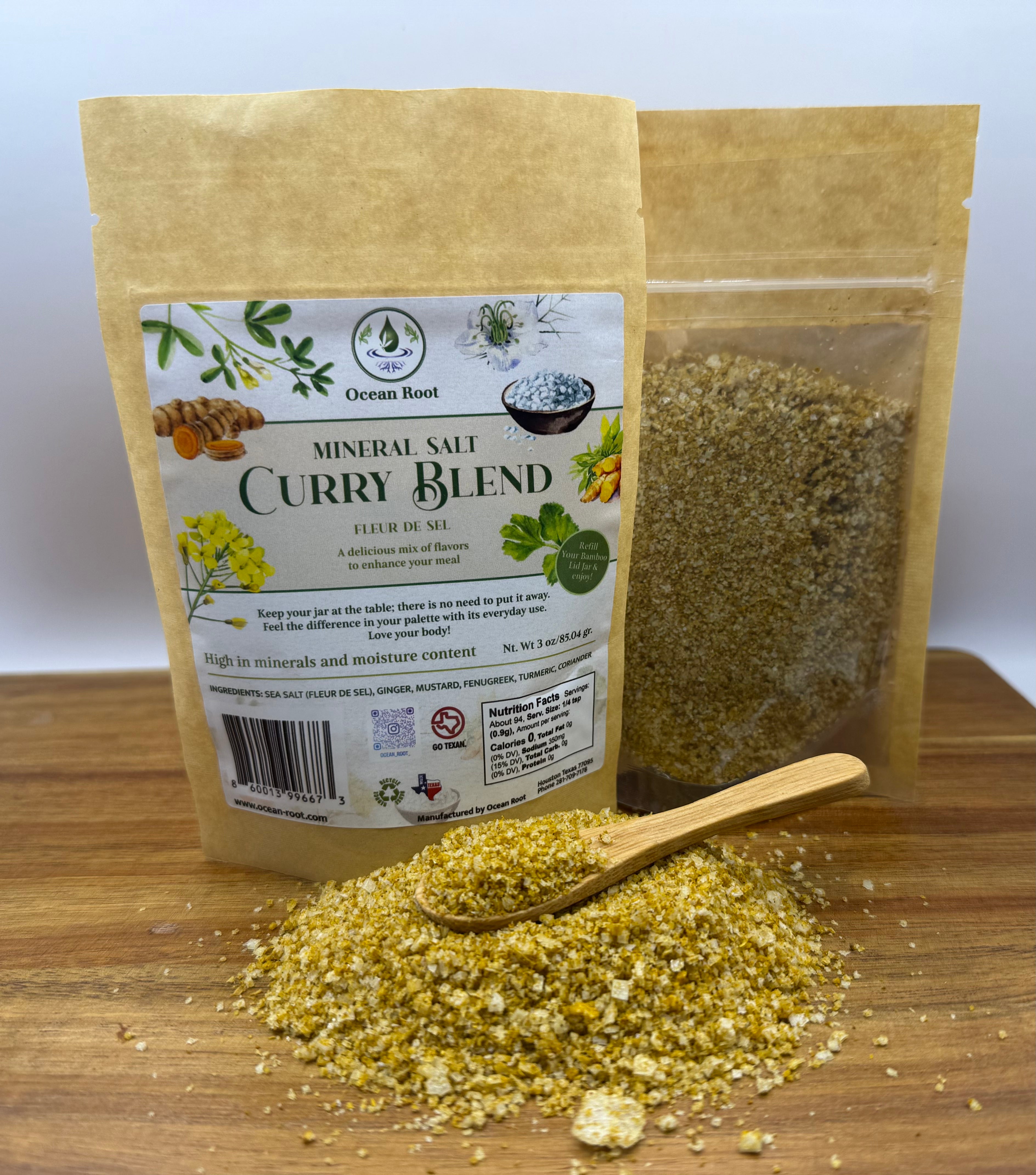 Curry blend mineral salt refill pouch with wooden spoon and loose seasoning displayed on wood.