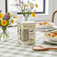 Box of 'French Blend' salt on a checkered tablecloth with flowers and pasta in the background