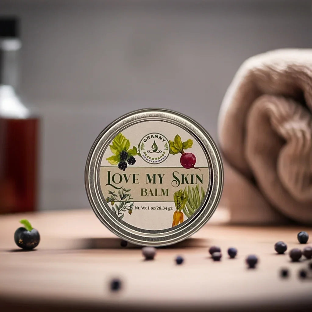 Natural Love My Skin balm tin on wooden surface with berries and towel, skincare product