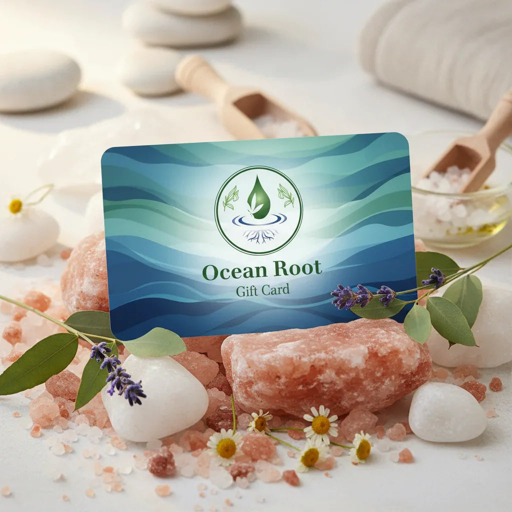 Gift card surrounded by pink Himalayan salt, white stones, lavender, chamomile, and spa items