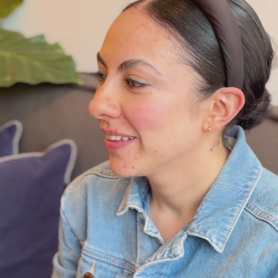 A you lady with stuffy nose smelling and applying Eucalyptus and Cedar wood body cream and feeling good.